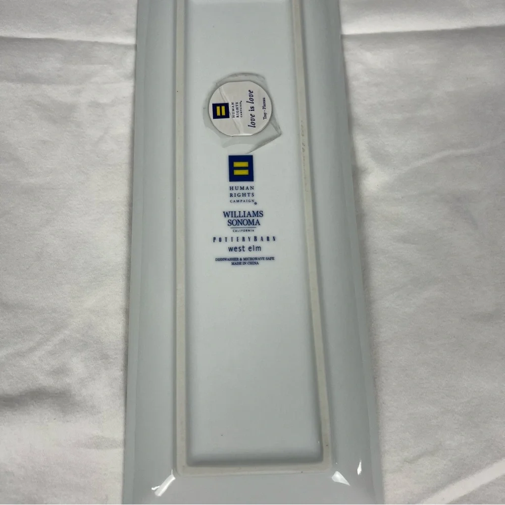 Williams Sonoma Love is Love tray with gold trim and multicolored hearts.